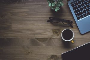 Workspace, coffee, laptop — Save Time and Money with Free Tenant Screening Tools