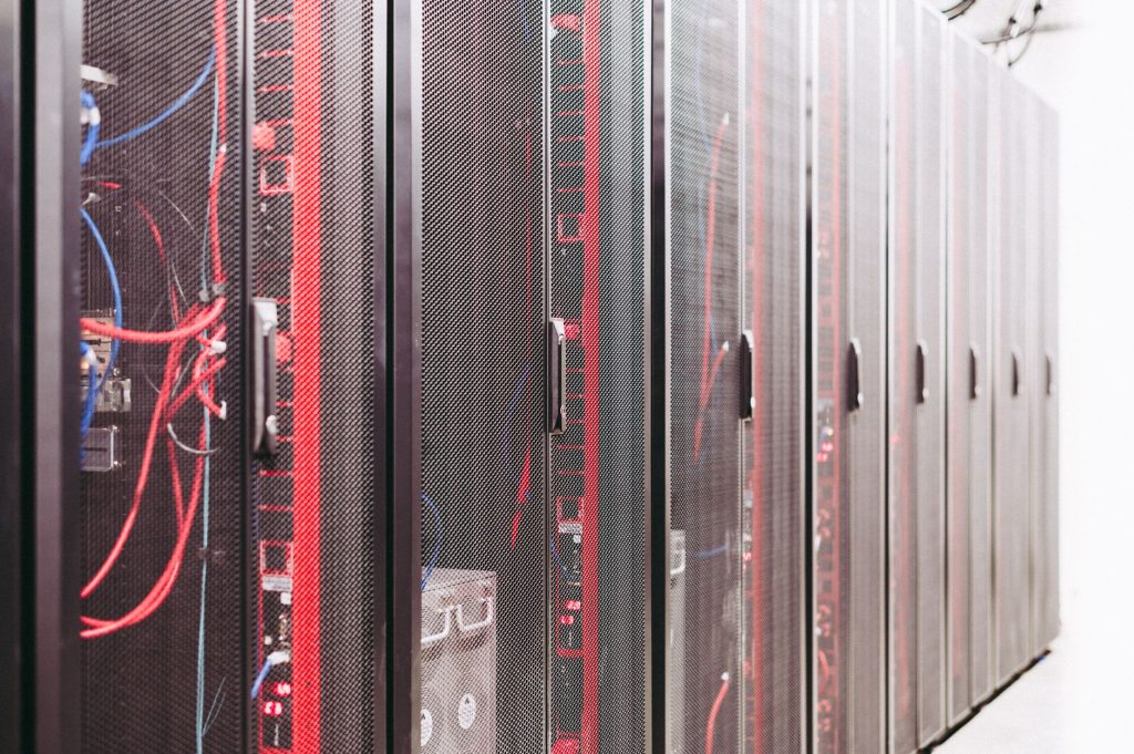A row of server racks with visible wiring in a data center