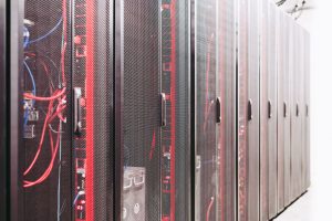 A row of server racks with visible wiring in a data center