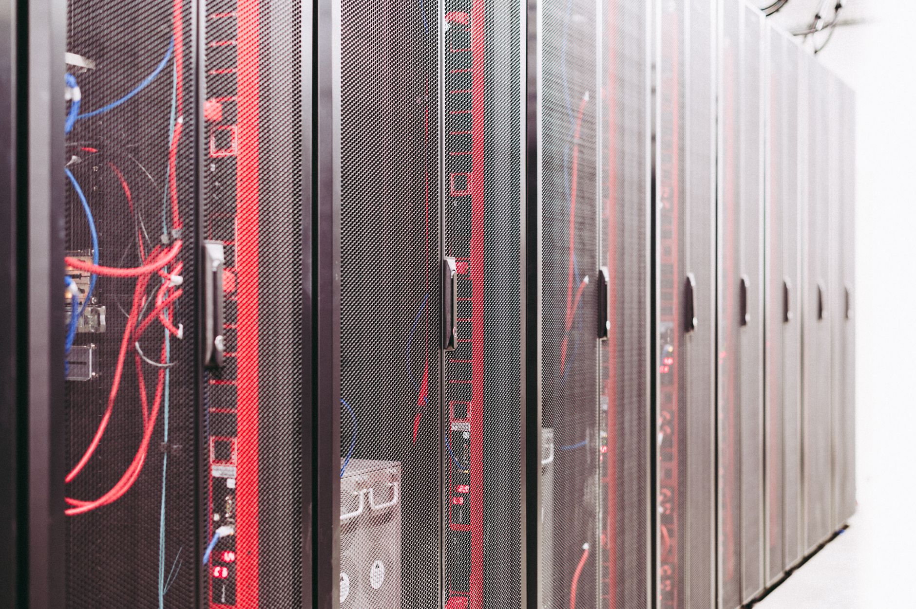 A row of server racks with visible wiring in a data center